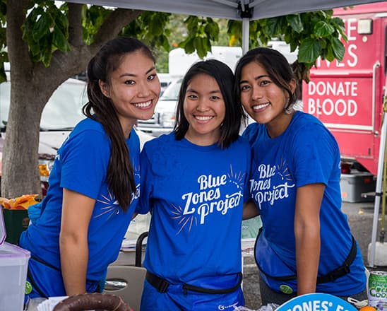 Three Blue Zones Project volunteers tabling at a community event